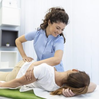 young-woman-doctor-chiropractor-osteopath-fixing-lying-womans-back-with-hands-movements-during-visit-manual-therapy-clinic-professional-chiropractor-during-work-scaled-3jcmer30kvaobvbhmbw0zu